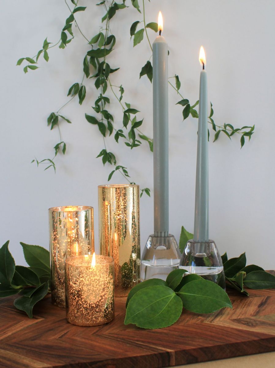 Image of sage green taper candles in candle holders and gold mercury glass candle holders in dining table setting